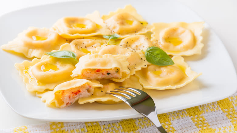 lobster ravioli on white plate with fork