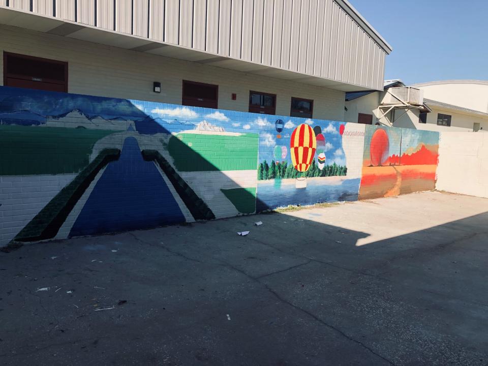 Lake Weir Middle School students painted these murals on campus. They depict the past (Versailles garden-like scene); the present (hot air balloons); and the future, with a space landscape.