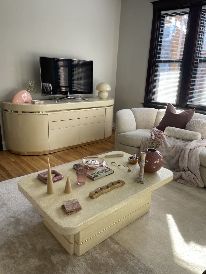 Rounded edge modern white coffee table, 80's vintage rounded oval tv console in cream, boucle white sofa, beige rug