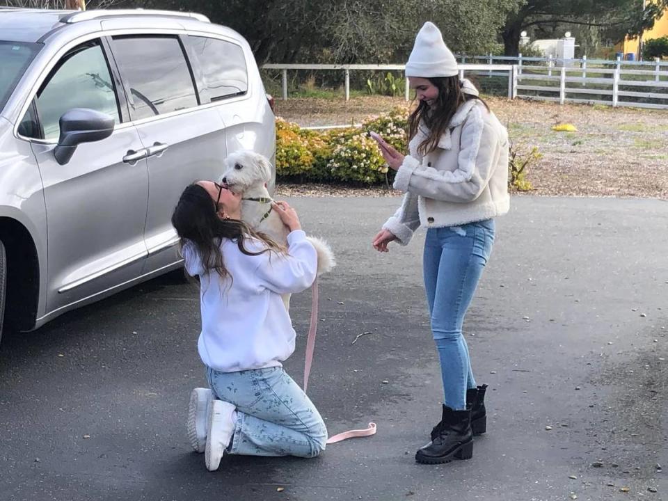 Tuti jumps into the arms of Nour Makhoul as the two are reunited in San Luis Obispo in January 2024, while her sister Rawan Makhoul looks on. It was the first time Makhoul had seen her beloved pet since the two were separated when Makhoul fled Syria in April 2023.