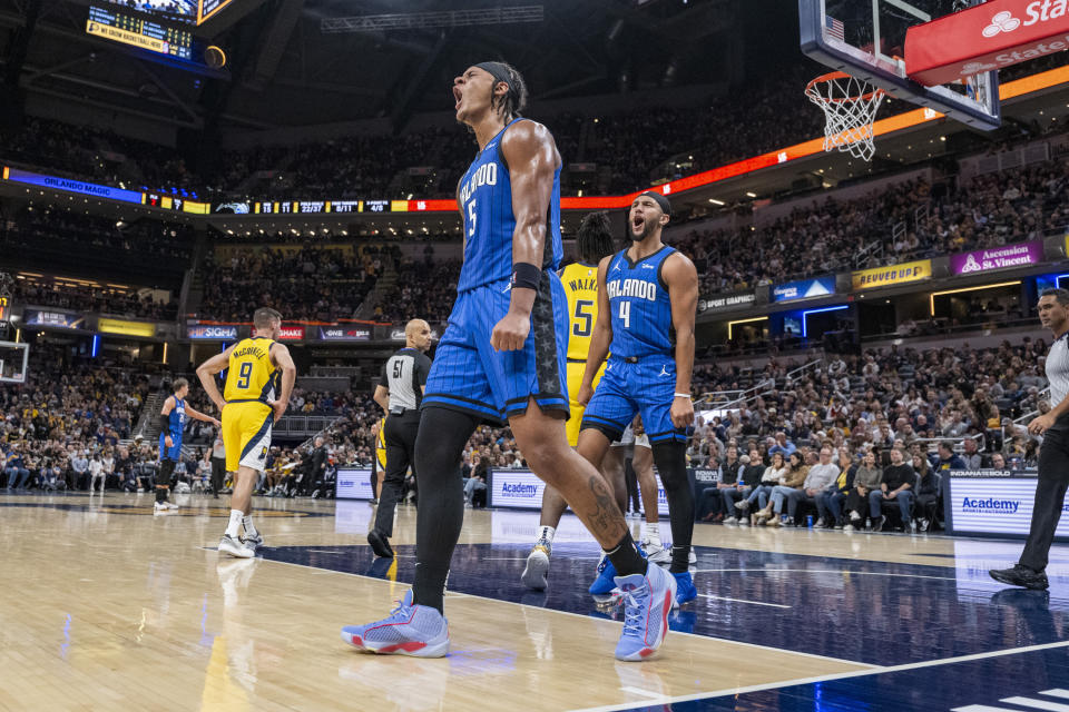 Orlando Magic forward Paolo Banchero (5) and guard Jalen Suggs (4) react after a favorable call during the first half of an NBA basketball game against the Indiana Pacers in Indianapolis, Sunday, Nov. 19, 2023. (AP Photo/Doug McSchooler)