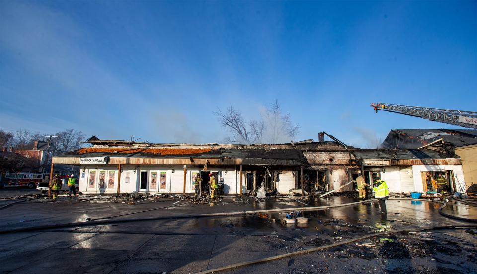 Louisville firefighters work the scene at the corner of 18th and W. Jefferson street after an overnight fire destroyed the Russell neighborhood strip mall early Wednesday morning. Dec. 21, 2022