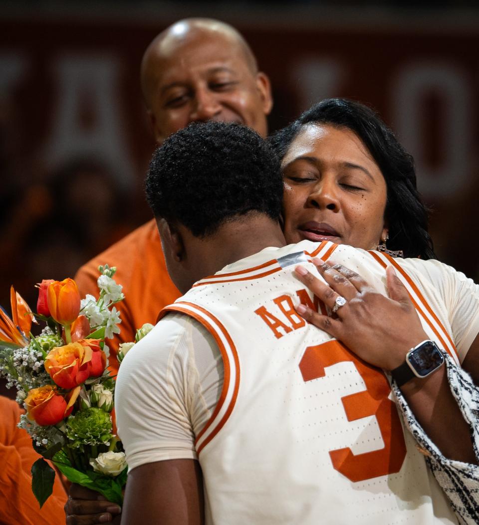 Texas guard Max Abmas embraces his family during Senior Day festivities ahead of the Longhorns' 94-80 win over Oklahoma last Saturday at Moody Center. It was Abmas' final home game.