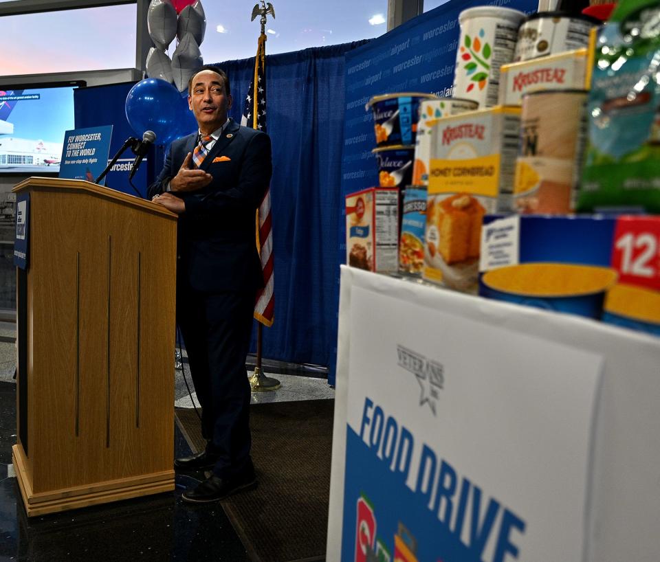 Vin Perrone, president and CEO of Veterans Inc., speaks near a food drive for Veterans Inc. during a Massport ceremony at Worcester Airport.