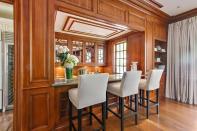 <p>And there’s a handsome wood bar. (Sotheby’s International Realty) </p>
