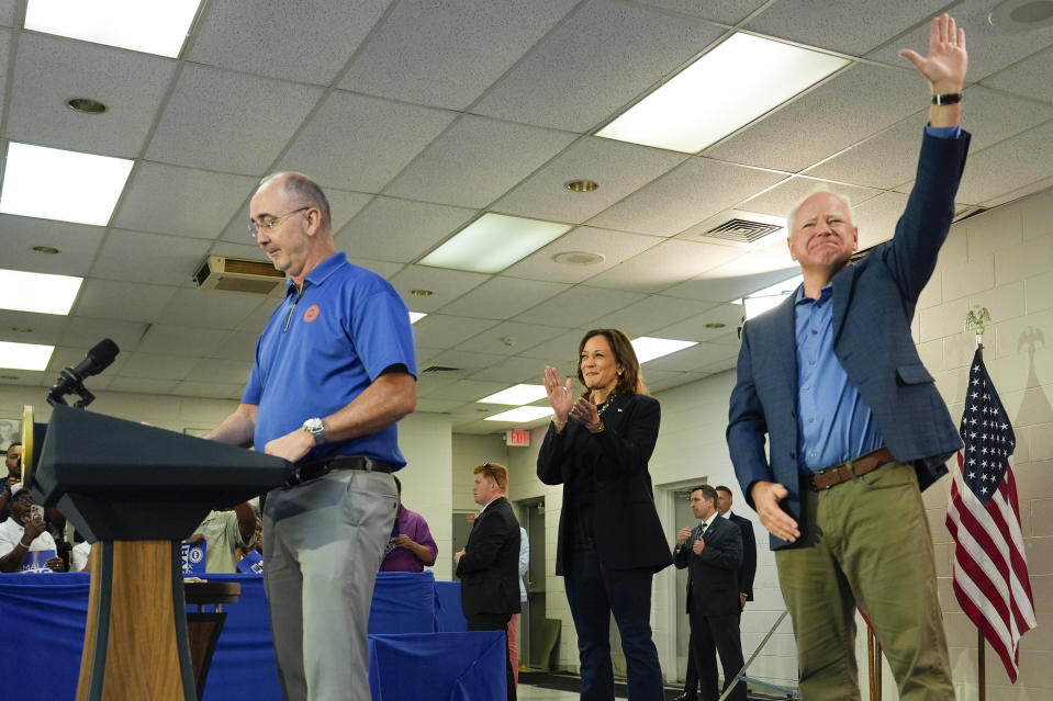 FILE - Shawn Fain, President of the United Auto Workers, left, is joined by Democratic presidential nominee Vice President Kamala Harris, center, and Democratic vice presidential nominee Minnesota Gov. Tim Walz, at a campaign rally at UAW Local 900, August 8, 2024, in Wayne, Mich. (AP Photo/Julia Nikhinson, File)