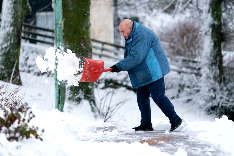 A man clears snow away in Leadhills, South Lanarkshire earlier this month