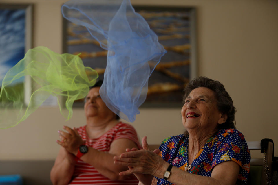 Elderly residents clap before catching coloured scarves during an activity session run by ACTive Age Malta at Hilltop Gardens retirement village in Naxxar, Malta, July 3, 2017. REUTERS/Darrin Zammit Lupi