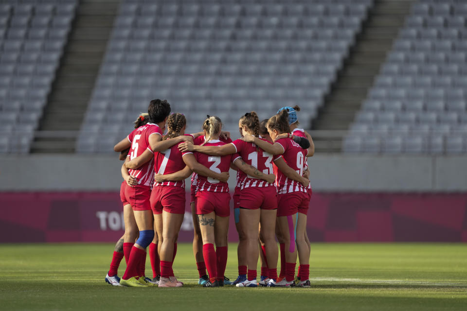 Russian Olympic Committee team players huddle up at the start of their women's rugby sevens 7-8 placing match against China at the 2020 Summer Olympics, Saturday, July 31, 2021 in Tokyo, Japan. (AP Photo/Shuji Kajiyama)