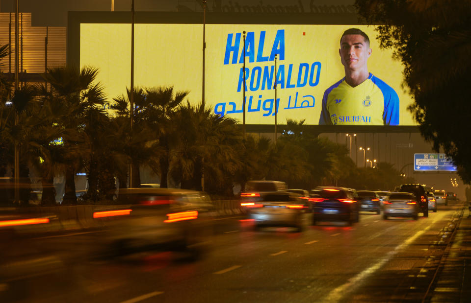 Vehicles pass under a billboard showing Cristiano Ronaldo with Arabic reading, "Welcome Ronaldo", in Riyadh, Saudi Arabia, late Monday, Jan 2, 2023. Ronaldo completed a lucrative move to Saudi Arabian club Al Nassr on Friday in a deal that is a landmark moment for Middle Eastern soccer but will see one of Europe's biggest stars disappear from the sport's elite stage. (AP Photo/Amr Nabil)