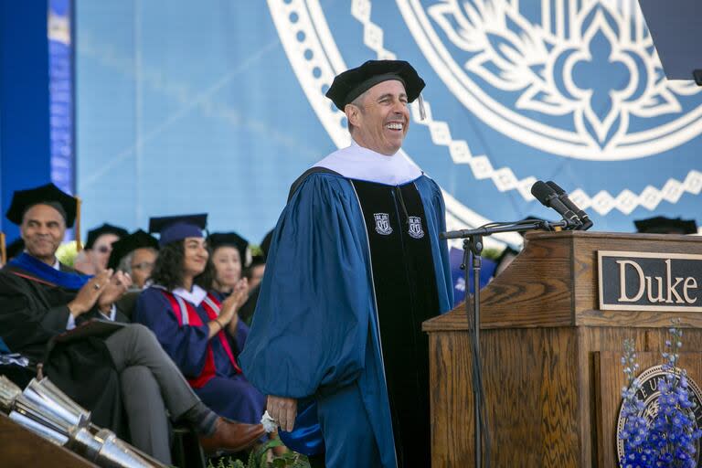 En esta foto proporcionada por la Universidad de Duke, el orador de graduación Jerry Seinfeld se ríe en el escenario durante la ceremonia de graduación de la escuela, el domingo 12 de mayo de 2024, en Durham, Carolina del Norte