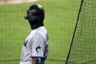 Miami Marlins' Lewis Brinson wears a face mask to protect against COVID-19 while standing at the on deck circle during the sixth inning of a baseball game against the Baltimore Orioles, Tuesday, Aug. 4, 2020, in Baltimore. (AP Photo/Julio Cortez)