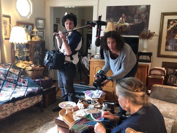 Sound recordist Curtis McNevin, left, and videographer Mille Clarkes, right, shoot a scene with quilter Penelope Player for the TV1 series Threading the Needle by Louise Lalonde Productions. 