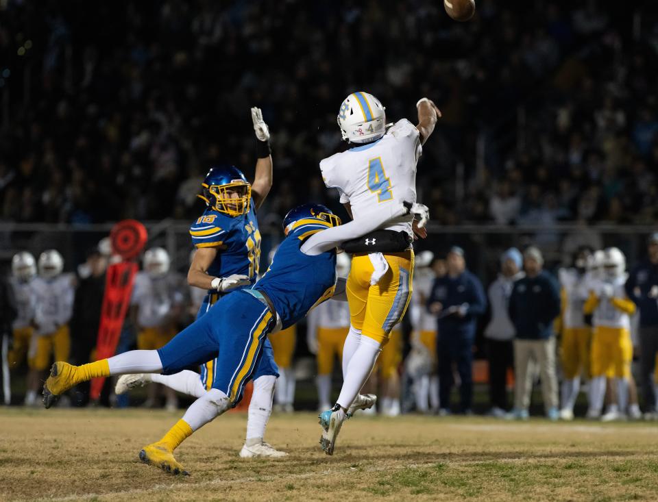 Sussex Central's Kyle Custis (8) stops a pass attempt by Cape Henlopen's Jameson Tingle (4) in the DIAA Class 3A football semifinal game at Sussex Central High School.