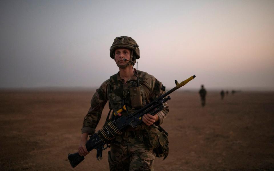 A soldiers from 40 Commando, Royal Marines walk towards their objective during exercise 'Saif Sareea 3'