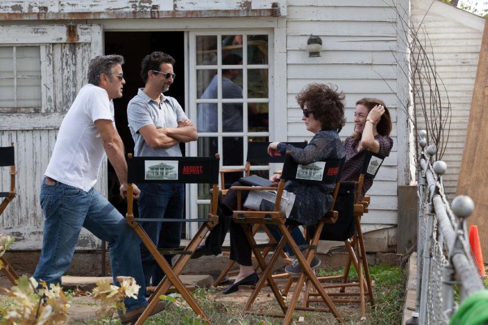 This image released by The Weinstein Company shows, from left, producers George Clooney, Grant Heslov, and actresses Meryl Streep, and Julianne Nicholson on the set of "August: Osage County." Streep was nominated for a Golden Globe for best actress in a motion picture musical or comedy for her role in the film. (AP Photo/The Weinstein Company, Claire Folger)