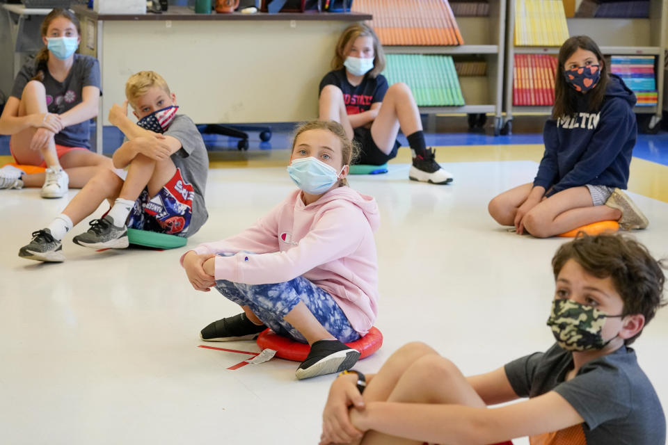 FILE - In this May 18, 2021 file photo, fifth graders wearing face masks are seated at proper social distancing during a music class at the Milton Elementary School in Rye, N.Y. As the nation closes out a school year marred by the pandemic, some states are now starting to release new standardized test scores that offer an early glimpse at just how far students have fallen behind — with some states reporting that the turbulent year has reversed years of progress across every academic subject. New York, Georgia and some other states pushed to cancel testing for a second year so schools could focus on classroom learning. (AP Photo/Mary Altaffer, File)