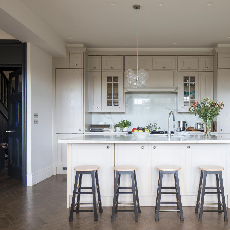 cream kitchen with island and black painted bar stools