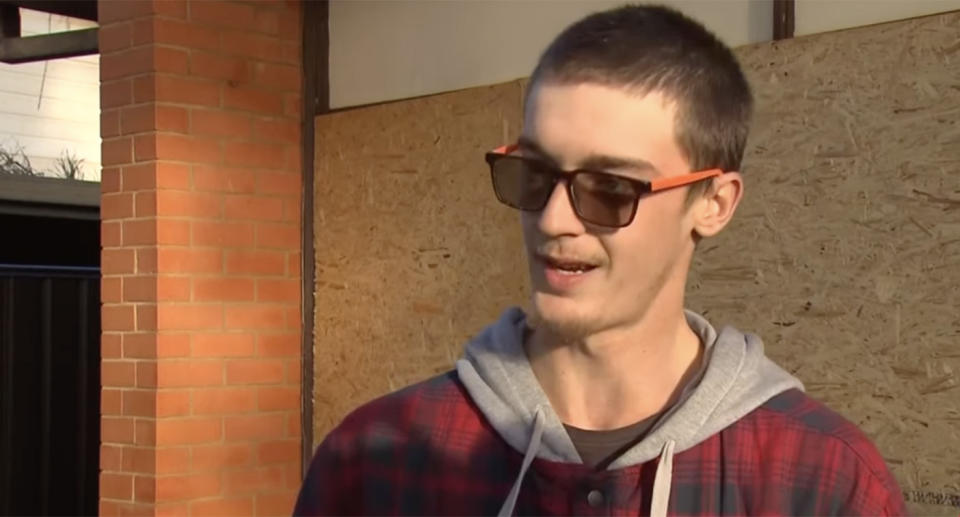 Lachlan Cameron speaks outside his home, which he accidentally set on fire.
