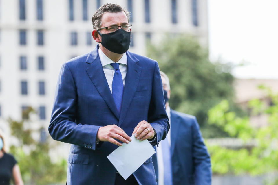 Daniel Andrews with a face mask on is pictured.