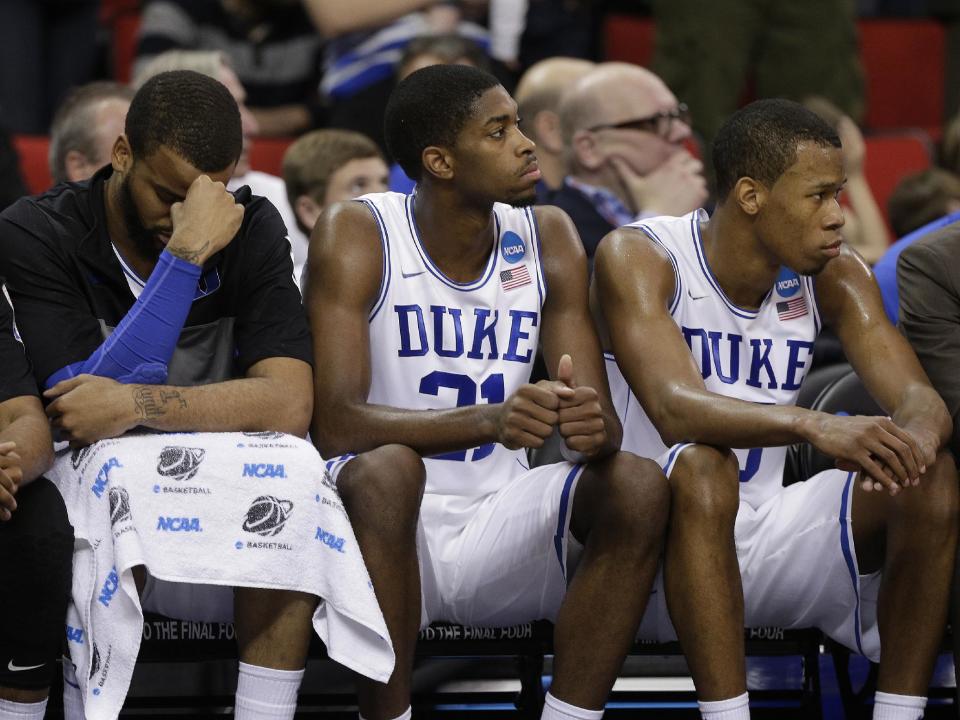 Duke's Josh Hairston, Amile Jefferson and Rodney Hood sit on the bench during the second half of an NCAA college basketball second-round game against Mercer, Friday, March 21, 2014, in Raleigh, N.C. Mercer won 78-71. (AP Photo/Chuck Burton)