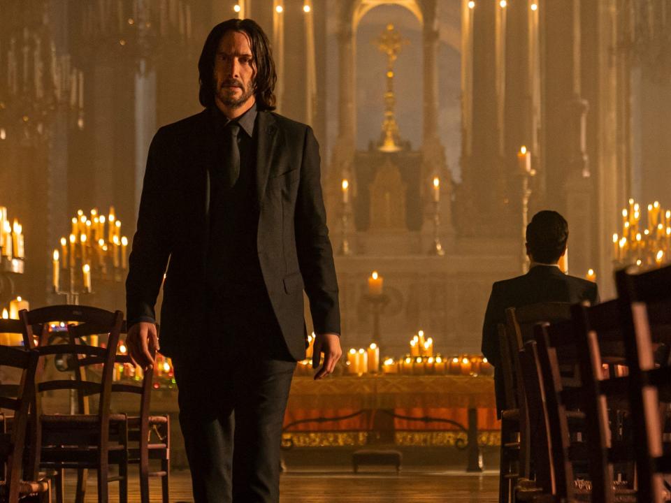 Keanu Reeves walking in a church