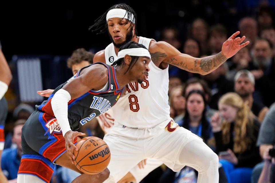 Cleveland Cavaliers forward Lamar Stevens (8) defends against Oklahoma City Thunder guard Shai Gilgeous-Alexander during the first half of an NBA basketball game Friday, Jan. 27, 2023, in Oklahoma City. (AP Photo/Nate Billings)