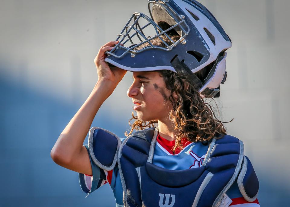Dave's catcher Jeremiyah Ramos takes a breather in between pitches on a very hot and muggy evening at Whaling City Youth Baseball in New Bedford's north end.