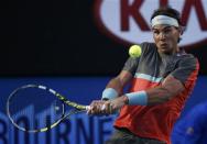 Rafael Nadal of Spain hits a return to Roger Federer of Switzerland during their men's singles semi-final match at the Australian Open 2014 tennis tournament in Melbourne January 24, 2014. REUTERS/Jason Reed