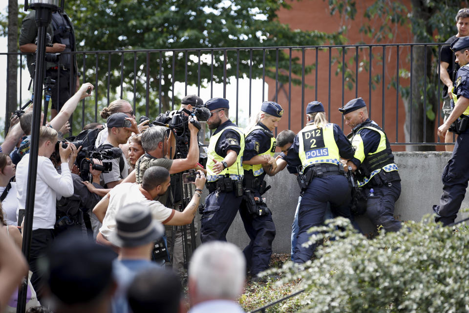 Police members try to restrain a man outside Stockholm's mosque at Medborgarplatsen, Sweden, Wednesday June 28, 2023. Stockholm police on Friday July 14, 2023 said they have authorized a protest this weekend by a man who has stated that he wants to burn the Torah and the Bible outside the Israeli Embassy in Stockholm. (Caisa Rasmussen/TT News Agency via AP)