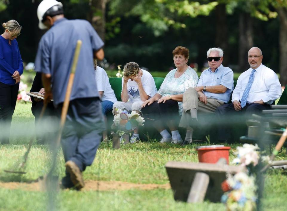In this file photo, Penny Lovett Lakoskey drops her head as cemetery workers finish reburying the remains of her daughter, Tina Lovett, on Aug. 31, 2017. Tina Lovett was 17 when she was murdered in 1984 seven miles from her Jacksonville, FL home. Her family believed they had buried all of her badly decomposed remains at Riverside Memorial Park. But they were shocked to learn 33 years later that the majority of her remains had instead been shuffled between various agencies around Florida before being returned to the Jacksonville Medical Examiner’s office.