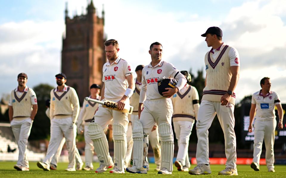 Sam Cook and Dean Elgar of Essex alongside Migael Pretorius of Somerset make their way off following Day One of the Vitality County Championship match between Somerset and Essex