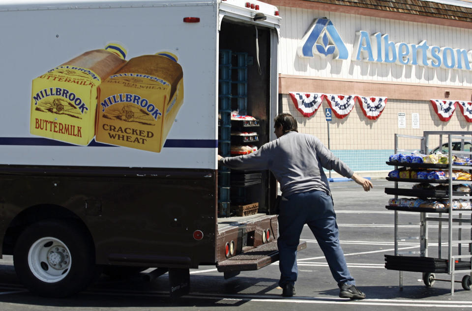 FILE - Mitch Maddox, a bread route salesman, loads bread Tuesday, May 30, 2006, outside the Eagle Rock Albertsons store in Los Angeles. The Federal Trade Commission on Monday, Feb. 16, 2024, sued to block a proposed merger between grocery giants Kroger and Albertsons, saying the $24.6 billion deal would eliminate competition and lead to higher prices for millions of Americans.(AP Photo/Damian Dovarganes, File)