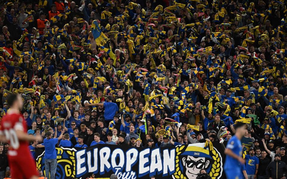 Union fans wave their scarves during the UEFA Europa League group E football match between Liverpool and Royale Union Saint-Gilloise