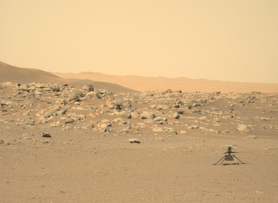 a small robotic helicopter sits on the surface of Mars