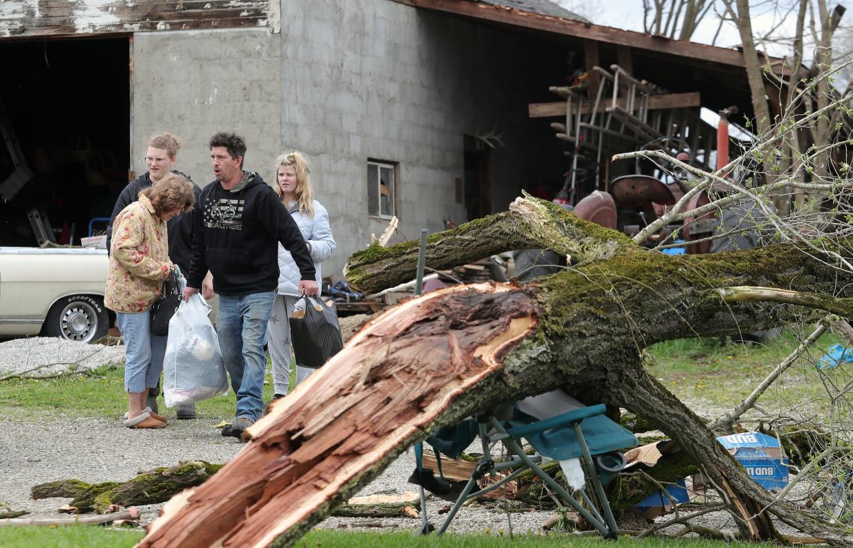 Aherin Silver gathers belongings from the rubble of his family's home Thursday, April 18, 2024, after an EF-1 tornado struck Wednesday, April 17, 2024, in Windham.