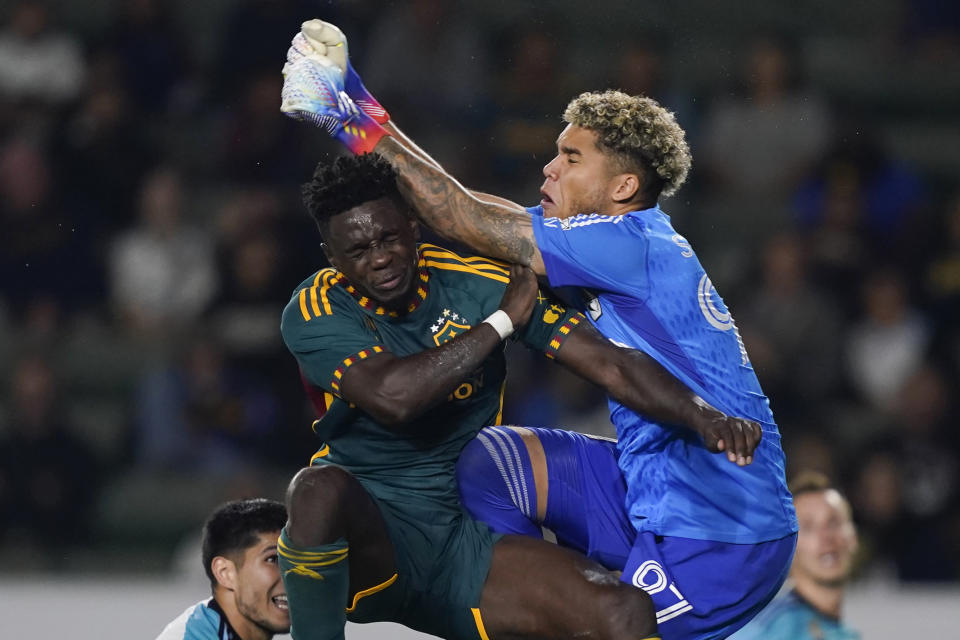 LA Galaxy defender Chris Mavinga, left, collides with Minnesota United goalkeeper Dayne St. Clair during the first half of an MLS soccer match Wednesday, Sept. 20, 2023, in Carson, Calif. (AP Photo/Ryan Sun)