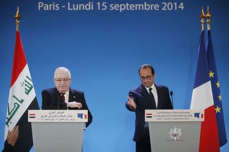 French President Francois Hollande (R) and Iraq's President Fuad Masum attend the opening of an international conference bringing together about 30 countries to discuss how to cooperate in the fight against Islamic State militants in Paris September 15, 2014. REUTERS/Christian Hartmann