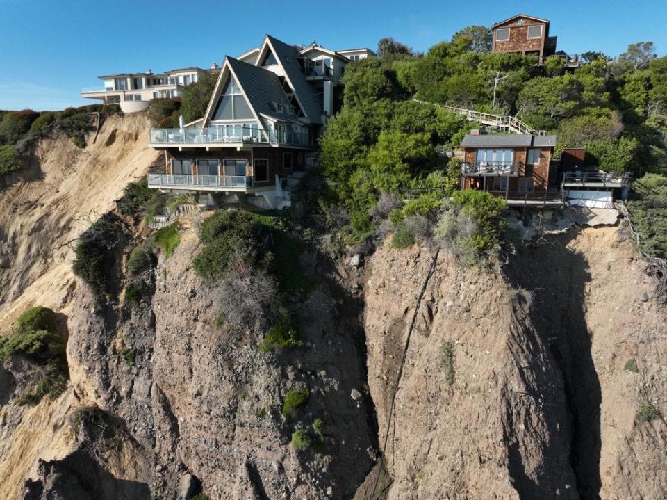 An aerial view of three large homes in Dana Point, California, after a cliffside gave way along Scenic Drive. - Copyright: Allen J. Schaben/Los Angeles Times via Getty Images