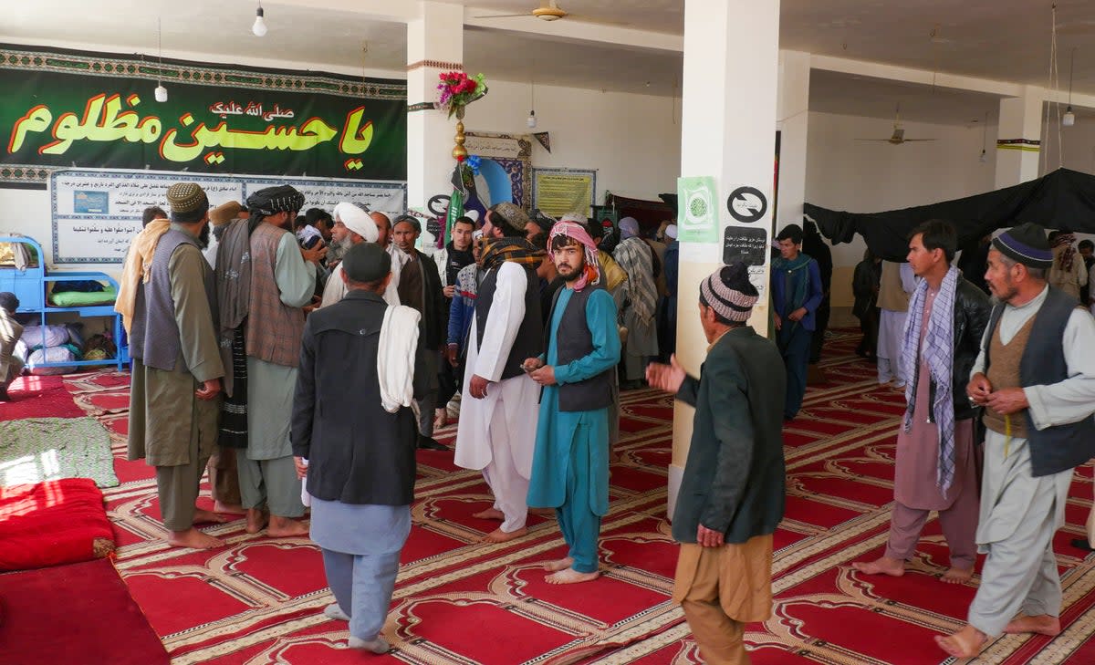 Afghans gather at a mosque where gunmen attacked Shiite Muslims in Guzara district of Herat province (AFP via Getty Images)