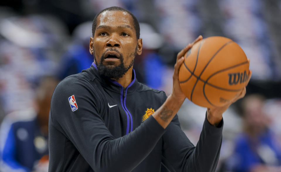 Phoenix Suns forward Kevin Durant warms up before an NBA basketball game against the Dallas Mavericks, Sunday, March 5, 2023, in Dallas. (AP Photo/Gareth Patterson)