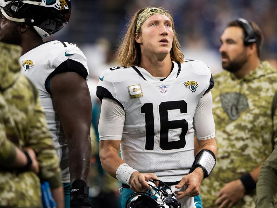 Trevor Lawrence looks up from the sidelines during a game against the Indianapolis Colts.