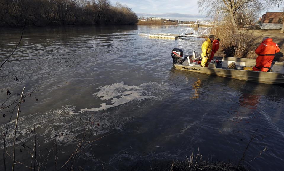 State and federal officials dock after collecting sediment samples as coal ash surfaces on the water on the Dan River in Danville, Va., Wednesday, Feb. 5, 2014. A coal ash spill from a break in a 48-inch storm water pipe at the Dan River Power Plant in Eden N.C. on Sunday released up to 82,000 tons of ash according to Duke Energy. (AP Photo/Gerry Broome)