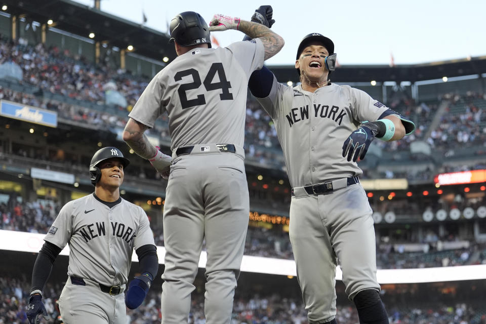 New York Yankees' Aaron Judge, right, is congratulated by Alex Verdugo (24) after hitting a three-run home run that scored Juan Soto, left, and Anthony Volpe during the third inning of the team's baseball game against the San Francisco Giants in San Francisco, Friday, May 31, 2024. (AP Photo/Jeff Chiu)