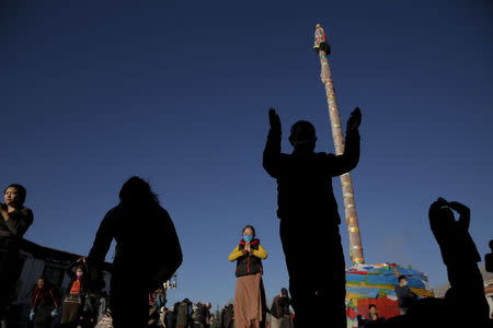 Pilgrims pray at the Jokhang Temple in central Lhasa, Tibet Autonomous Region, China as sun rises November 20, 2015. REUTERS/Damir Sagolj