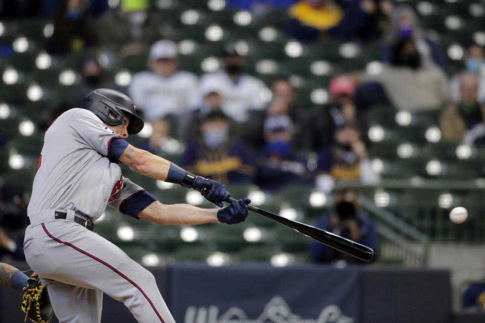 Minnesota Twins' Max Kepler hits an RBI single during the third inning of an opening day baseball game against the Milwaukee Brewers on Thursday, April 1, 2021, in Milwaukee. (AP Photo/Aaron Gash)