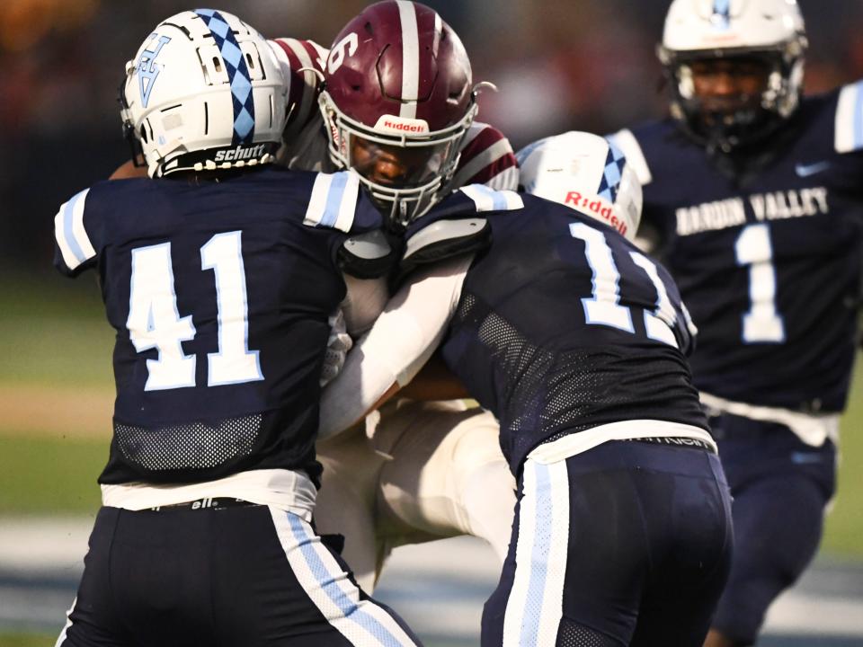 Bearden's Jayzon Thompson is stopped by Hardin Valley Academy's Nathan Holbrook (41) and Tommy Joseph (11) during the game last September. HVA coach Tyler Wynn inherits "a young team with 40-something sophomores who are eager to learn and play football."