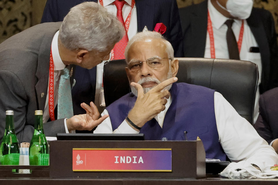 FILE - India's Prime Minister Narendra Modi, right, speaks with Foreign Minister Subrahmanyam Jaishankar at the G20 Leaders' Summit, in Nusa Dua, Bali, Indonesia, Wednesday Nov. 16, 2022. India and China, after months of refusing to condemn Russia’s war in Ukraine, did not stand in the way of the public release this week of a statement by the world’s leading economies that strongly criticizes Moscow. (Willy Kurniawan/Pool Photo via AP, File)
