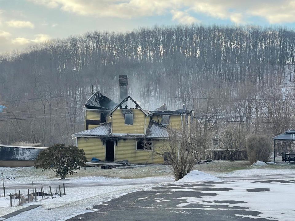 This photo shows the back of the home on Friday morning, with wisps of smoke still rising from the house.