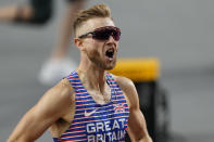 Josh Kerr, of Great Britain celebrates after winning the gold medal in the Men's 1500-meters final during the World Athletics Championships in Budapest, Hungary, Wednesday, Aug. 23, 2023. (AP Photo/Martin Meissner)